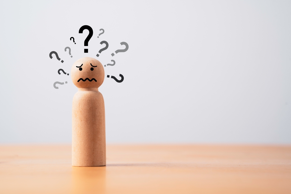 Wooden,Figure,With,Many,Questions,Mark,And,Copy,Space,For